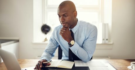 Man reading through online resources for machine shops | Custom Tool